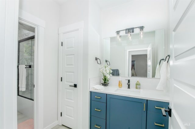 bathroom with vanity with extensive cabinet space and enclosed tub / shower combo