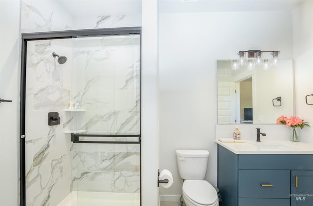 bathroom featuring a shower with shower door, oversized vanity, and toilet