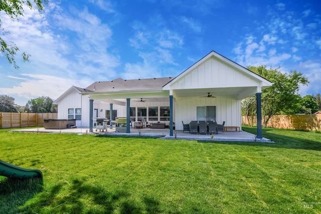 back of property with ceiling fan, outdoor lounge area, a lawn, and a patio area