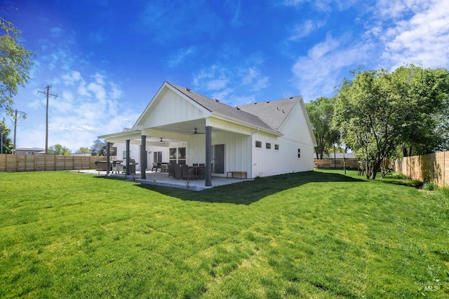 rear view of property featuring ceiling fan, a lawn, and a patio