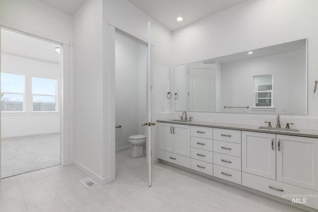 2372 N Leatherwood Ave, Star, ID 83669 - full bathroom featuring double vanity, toilet, baseboards, and recessed lighting