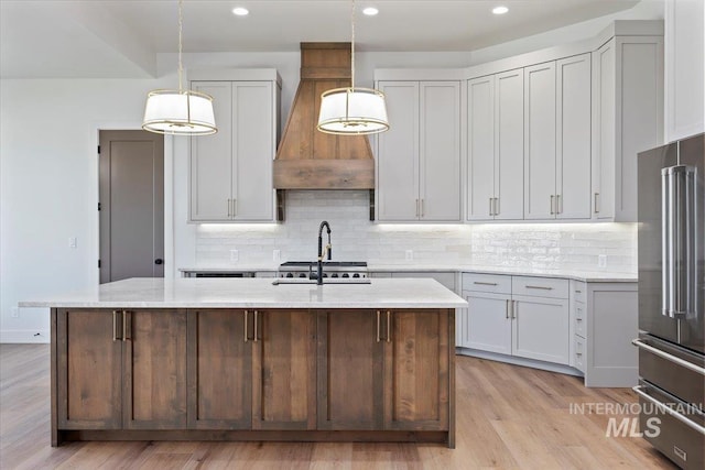 1967 Red Rock Way, Twin Falls, ID 83301 - kitchen featuring custom range hood, high end fridge, tasteful backsplash, light wood-style flooring, and recessed lighting