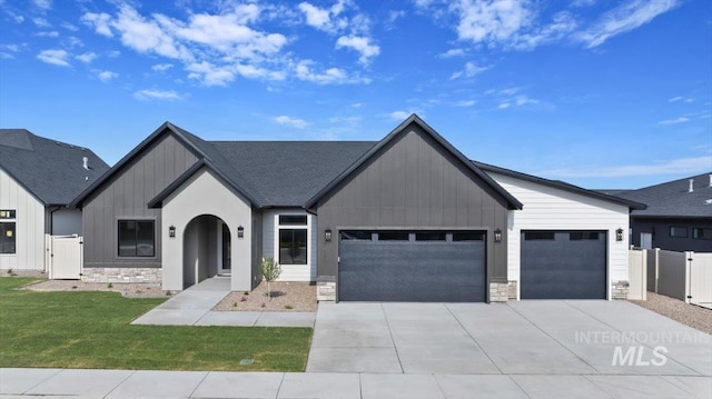 1967 Red Rock Way, Twin Falls, ID 83301 - view of front of home with board and batten siding, an attached garage, stone siding, and concrete driveway