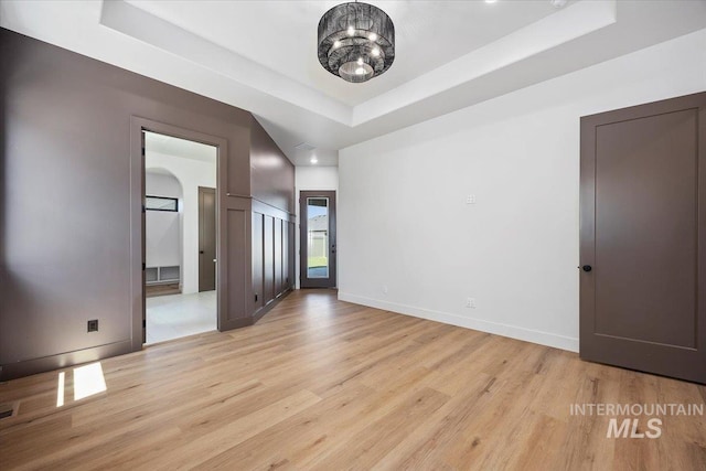 1967 Red Rock Way, Twin Falls, ID 83301 - spare room featuring a tray ceiling and light wood finished floors