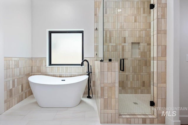 1967 Red Rock Way, Twin Falls, ID 83301 - bathroom with a stall shower, a soaking tub, tile walls, and a wainscoted wall