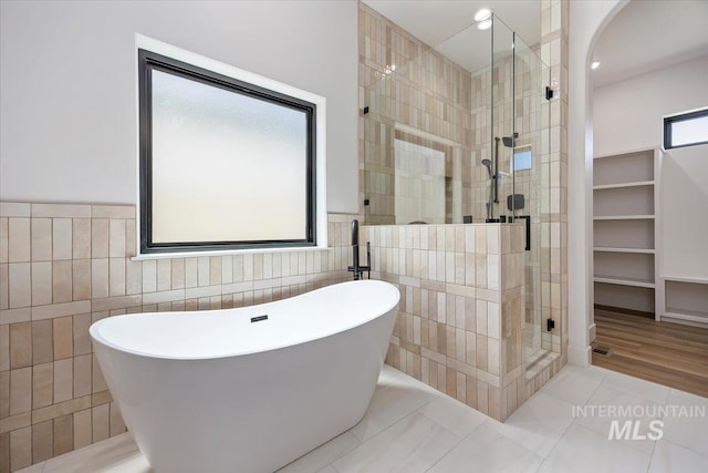 1967 Red Rock Way, Twin Falls, ID 83301 - full bathroom with tile walls, a stall shower, a freestanding tub, and tile patterned flooring