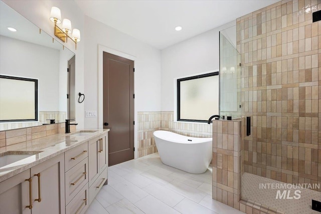 1967 Red Rock Way, Twin Falls, ID 83301 - bathroom featuring a shower stall, tile walls, a soaking tub, double vanity, and recessed lighting