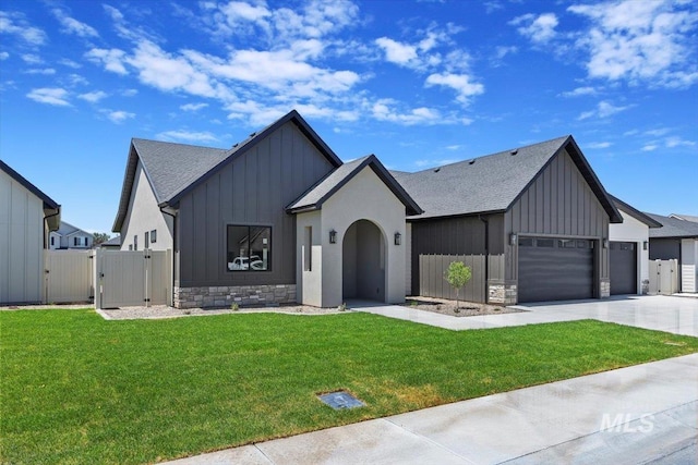 1967 Red Rock Way, Twin Falls, ID 83301 - modern farmhouse featuring board and batten siding, a gate, an attached garage, driveway, and roof with shingles