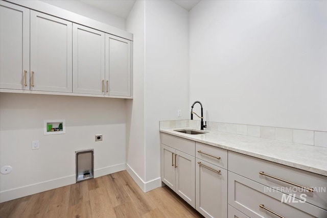 1967 Red Rock Way, Twin Falls, ID 83301 - laundry area featuring hookup for a washing machine, light wood-style flooring, hookup for an electric dryer, and cabinet space