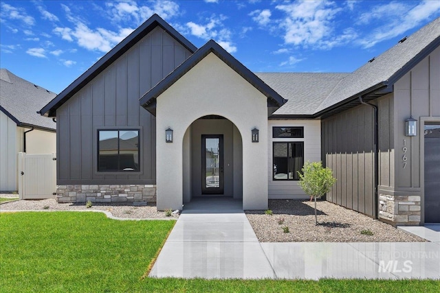 1967 Red Rock Way, Twin Falls, ID 83301 - view of front of house with board and batten siding, a front lawn, roof with shingles, and stone siding