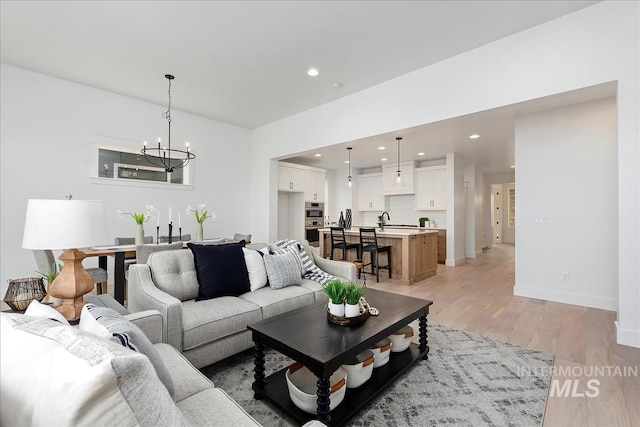 7625 W Whisper Ridge Dr, Meridian, ID 83646 - living room with a chandelier, light wood-type flooring, and recessed lighting