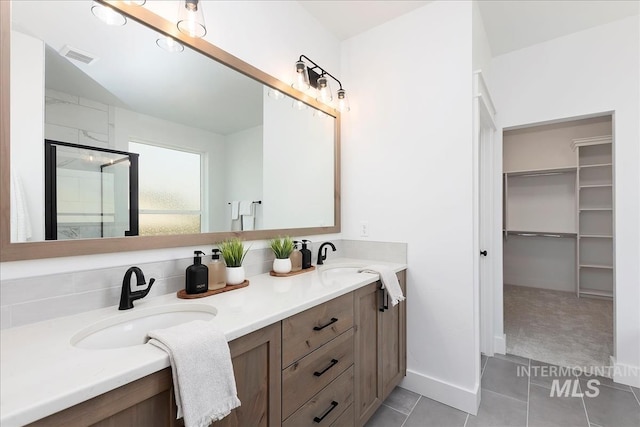 7625 W Whisper Ridge Dr, Meridian, ID 83646 - full bath featuring double vanity, a shower stall, tile patterned flooring, and a spacious closet
