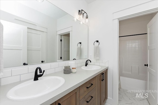 7625 W Whisper Ridge Dr, Meridian, ID 83646 - bathroom with marble look tile flooring, double vanity, bathing tub / shower combination, and decorative backsplash