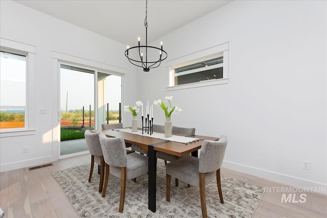 7625 W Whisper Ridge Dr, Meridian, ID 83646 - dining room featuring a chandelier and light wood-style flooring
