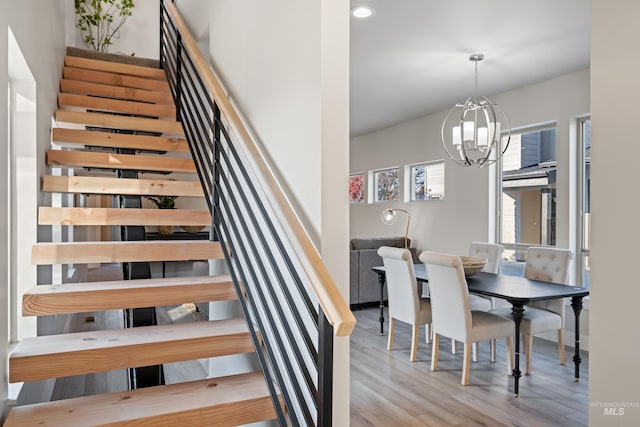 dining area featuring an inviting chandelier and light hardwood / wood-style floors