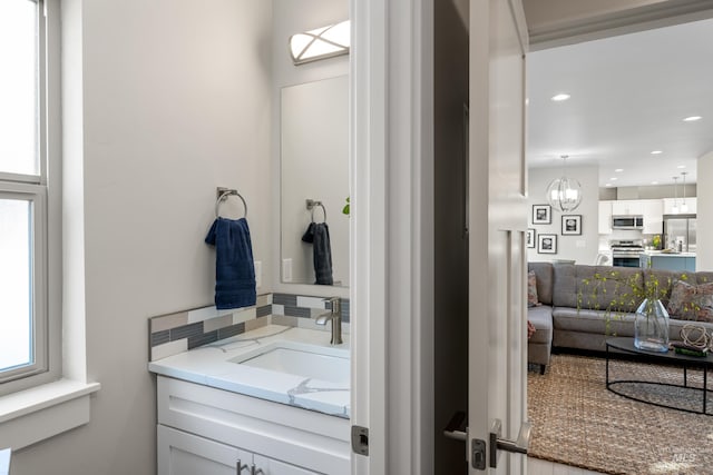 bathroom with a chandelier and vanity