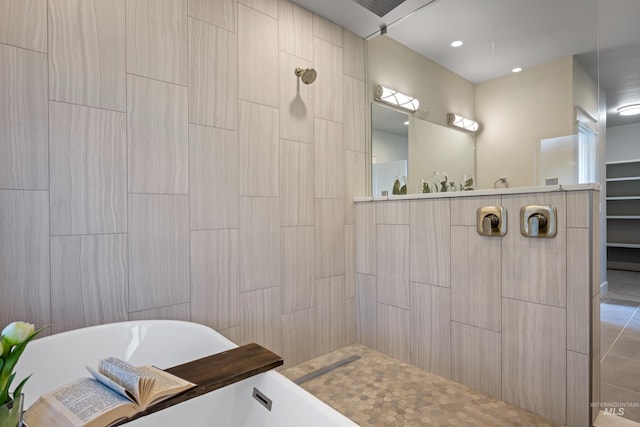 bathroom featuring tile walls, tile patterned floors, and separate shower and tub