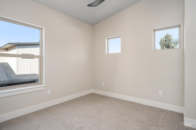 carpeted spare room with ceiling fan and a healthy amount of sunlight