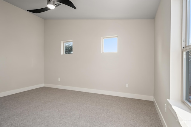 carpeted empty room featuring ceiling fan and vaulted ceiling