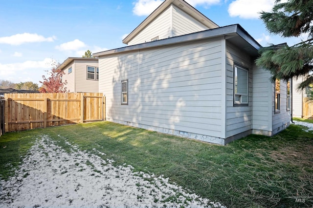 back of house with a lawn