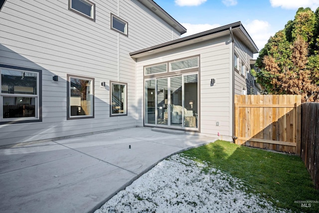 rear view of property with a patio and a lawn