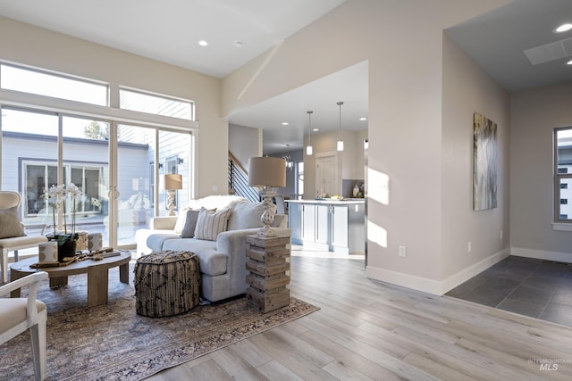 living room with plenty of natural light and light hardwood / wood-style floors