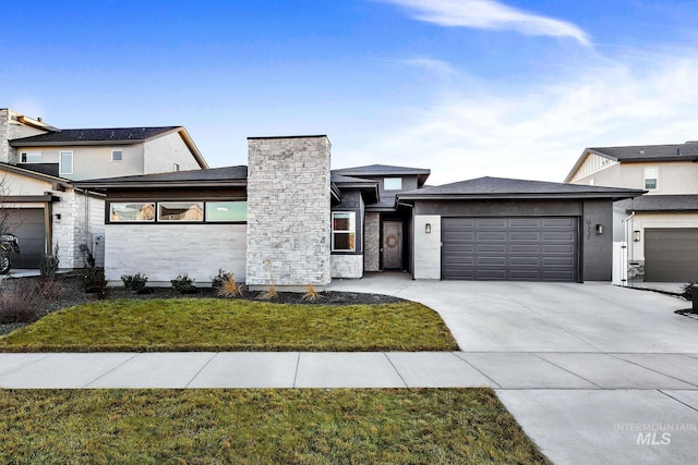 view of front of home with a garage and a front lawn