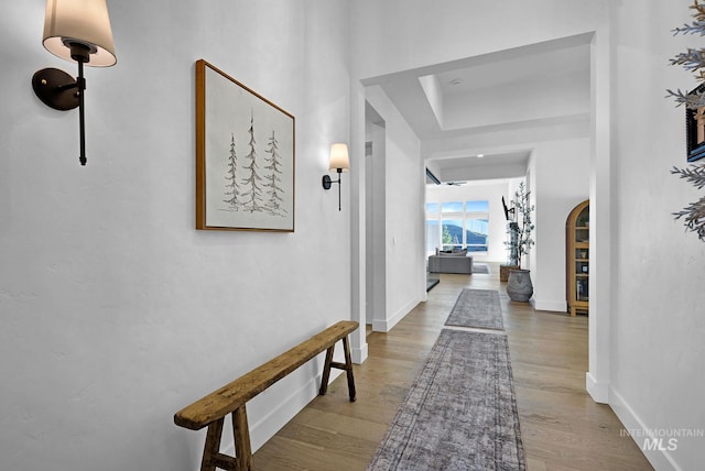 hallway with hardwood / wood-style flooring