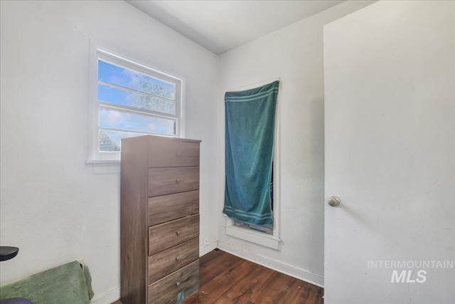 202E 2nd St, Shoshone, ID 83352 - unfurnished bedroom with wood finished floors and baseboards