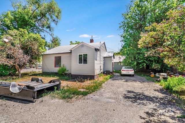 202E 2nd St, Shoshone, ID 83352 - back of house with a chimney and a metal roof