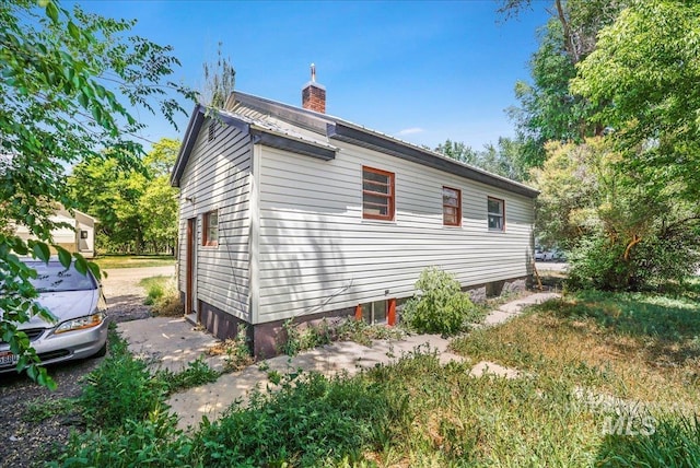 202E 2nd St, Shoshone, ID 83352 - view of side of home with a chimney