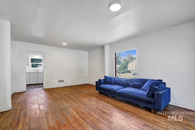 202E 2nd St, Shoshone, ID 83352 - living room featuring hardwood / wood-style floors and baseboards