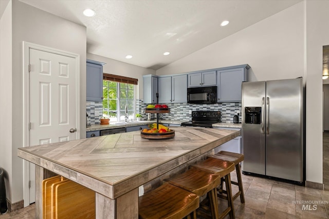 1814 N Rosedust Dr, Kuna, ID 83634 - kitchen featuring black appliances, decorative backsplash, recessed lighting, stone tile flooring, and light countertops