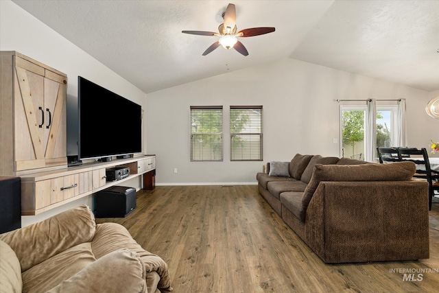 1814 N Rosedust Dr, Kuna, ID 83634 - living area with ceiling fan, lofted ceiling, wood finished floors, and baseboards