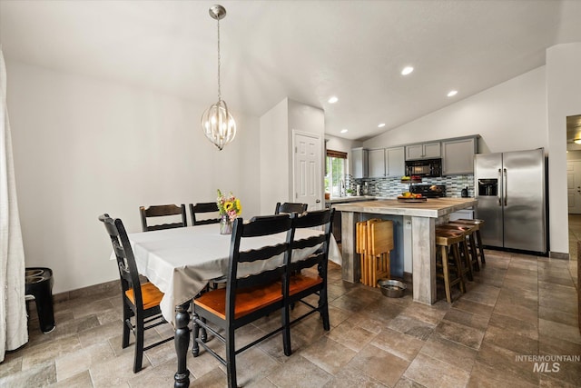 1814 N Rosedust Dr, Kuna, ID 83634 - dining space featuring lofted ceiling, a chandelier, recessed lighting, baseboards, and stone finish flooring