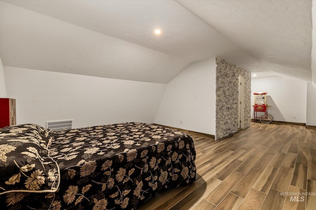 1814 N Rosedust Dr, Kuna, ID 83634 - bedroom with wood finished floors, lofted ceiling, and baseboards