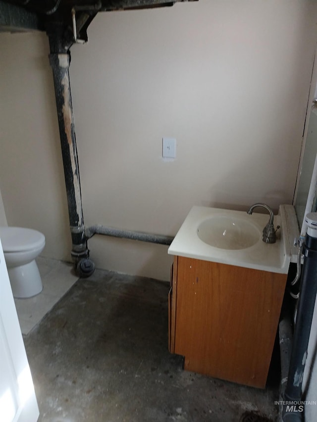 1126 12th St, Clarkston, WA 99403 - bathroom featuring vanity, toilet, and unfinished concrete flooring