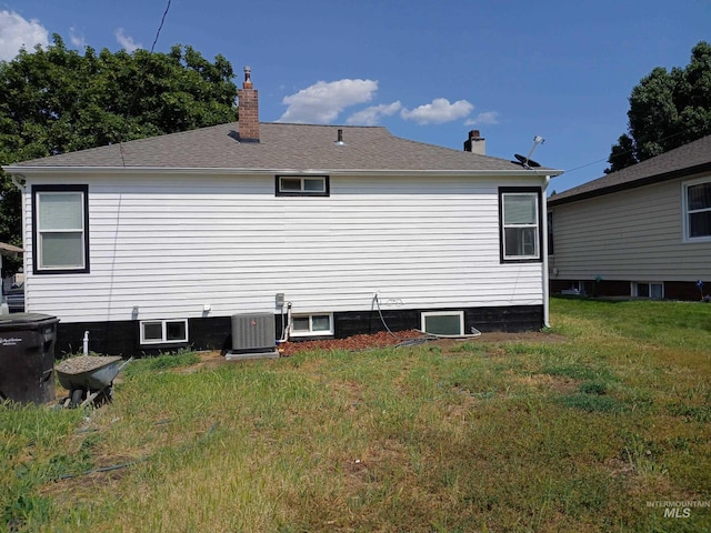 1126 12th St, Clarkston, WA 99403 - rear view of property with a chimney, central air condition unit, and a lawn