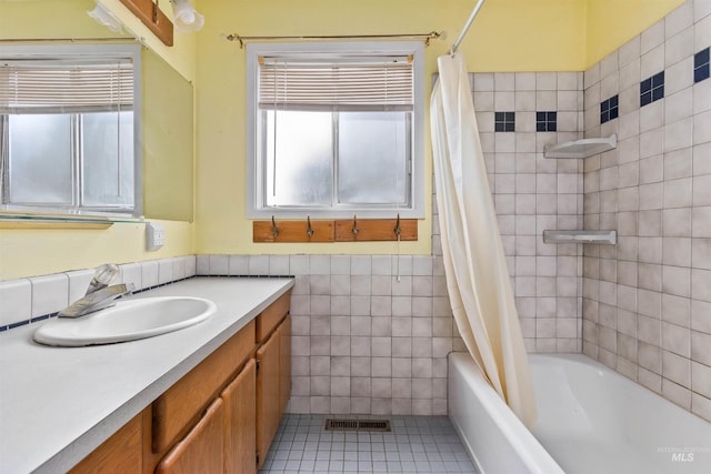 3709 11th St, Lewiston, ID 83501 - full bath featuring tile patterned flooring, vanity, visible vents, tile walls, and shower / tub combo