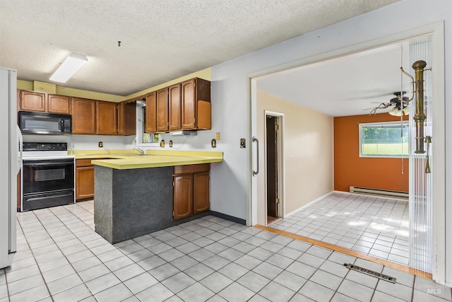 3709 11th St, Lewiston, ID 83501 - kitchen with black microwave, baseboard heating, light countertops, electric stove, and a peninsula