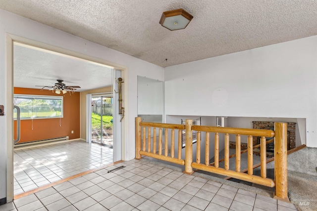 spare room featuring tile patterned flooring, a baseboard radiator, a textured ceiling, and ceiling fan