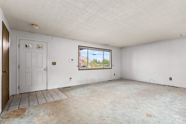 entryway with carpet flooring and a textured ceiling