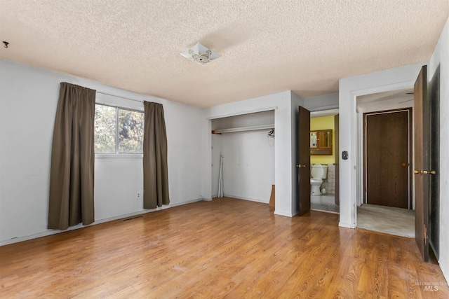 3709 11th St, Lewiston, ID 83501 - unfurnished bedroom featuring a textured ceiling, visible vents, baseboards, a closet, and light wood finished floors