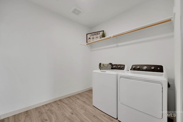 17869 N Onaway Ave, Nampa, ID 83686 - washroom featuring washing machine and clothes dryer, light wood-style flooring, and baseboards