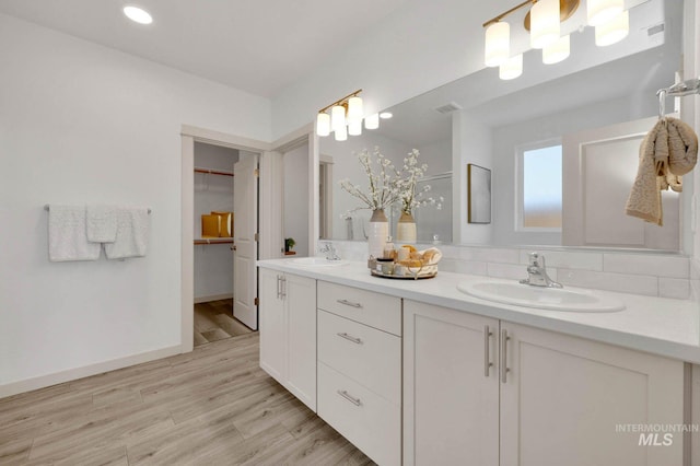 17869 N Onaway Ave, Nampa, ID 83686 - full bath featuring double vanity, a walk in closet, wood finished floors, recessed lighting, and baseboards