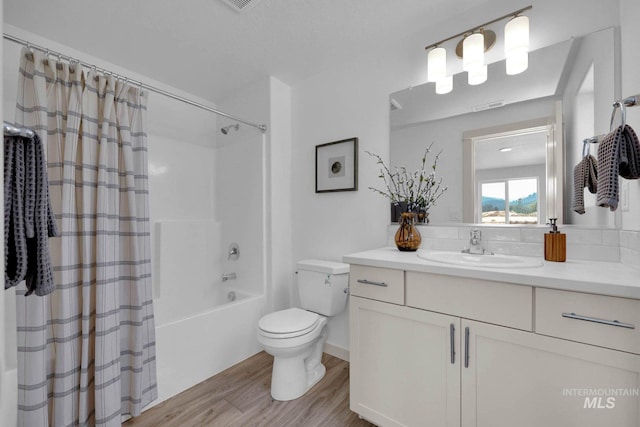 17869 N Onaway Ave, Nampa, ID 83686 - full bathroom featuring wood finished floors, toilet, vanity, and shower / tub combo with curtain