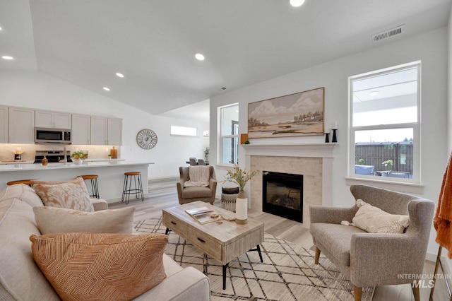 17869 N Onaway Ave, Nampa, ID 83686 - living room featuring a fireplace, light wood-style flooring, recessed lighting, and vaulted ceiling