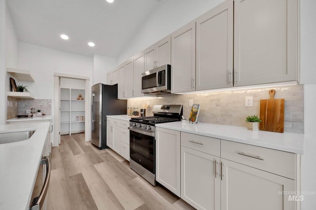 17869 N Onaway Ave, Nampa, ID 83686 - kitchen featuring stainless steel appliances, open shelves, tasteful backsplash, light countertops, and recessed lighting
