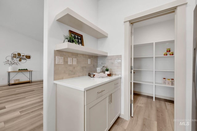 17869 N Onaway Ave, Nampa, ID 83686 - bar area featuring light wood-type flooring and decorative backsplash