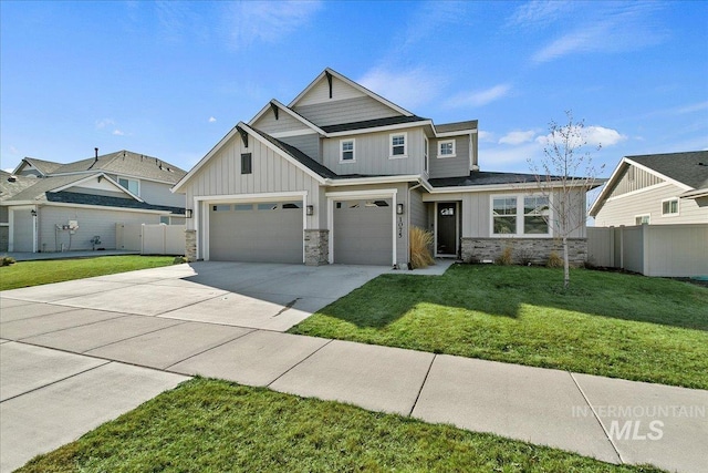view of front facade featuring stone siding, concrete driveway, fence, board and batten siding, and a front yard